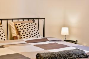 a bedroom with a bed with polka dot pillows at Bellevue Bjelasnica in Bjelašnica