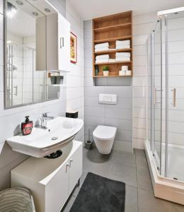 a bathroom with a sink and a toilet and a shower at Bellevue Bjelasnica in Bjelašnica