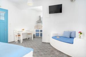 a room with a bed and a table with a tv at Castellano Village in Maltezana