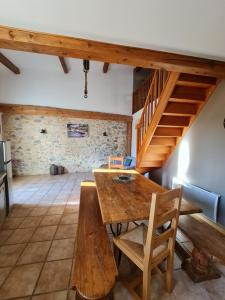 jadalnia z drewnianym stołem i schodami w obiekcie Maison Bergerie Glabanel w mieście Lapalme