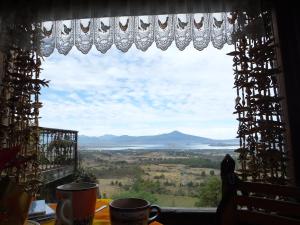 a window with a view of the plains and water at Eco Hotel Ixhi in Pátzcuaro