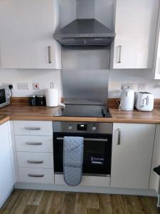 y cocina con fogones y horno. en Remarkable and modern house in Rugby England en Rugby