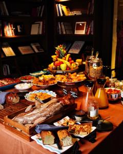 a table with a buffet of food on it at Hotel de Nell in Paris
