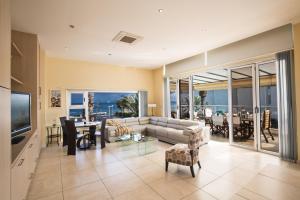 a living room with a couch and a table and a television at Pallini Court in Protaras
