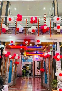 a lobby with red and white umbrellas hanging from the ceiling at Smart Stays in Gorakhpur