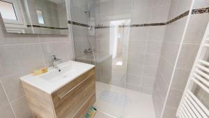 a white bathroom with a sink and a shower at Maison de vacances proche du Port in Saint-Gilles-Croix-de-Vie +17 photos