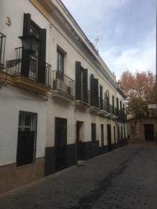 a row of buildings with balconies on a street at Apartamento con parking jesus del gran poder in Seville