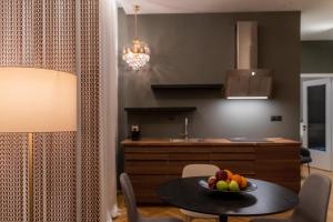 a kitchen with a table with a bowl of fruit on it at AN&VI Boutique Apartments Apt201 in Ioannina