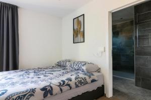 a bedroom with a bed and a glass shower at Hotel B&B MAMA MIA in Obrovac +89 photos