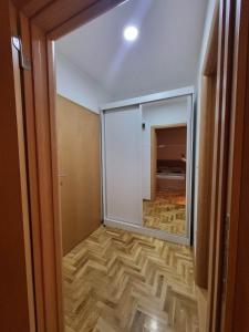 un corridoio con una grande porta a vetri e una camera di Apartman Ana a Žarkovo
