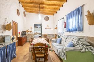 a living room with a couch and a table at Molino de Lucero, casa rural in Teba