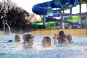 a group of people in the water at a water park at Sea Fern Luxury Cottage Fylingthorpe in Fylingthorpe