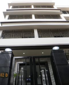 a facade of a building with black doors at Radharani Apartment in Kolkata