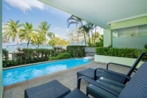 a house with a swimming pool and two chairs at HOMM Bliss Southbeach Patong in Patong Beach