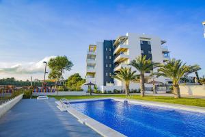 a swimming pool in front of a building at 216 Lux Penthouse Spa - Alicante-Holiday in Villamartin