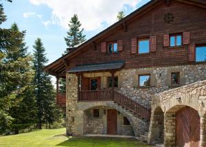 a large stone house with a balcony on it at Casa Pyrenees - Slow Life Refuge in La Molina