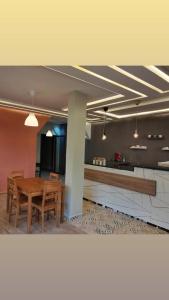 a dining area with a table and chairs in a room at Apartment Hotel With Restaurant & Parking in Taza