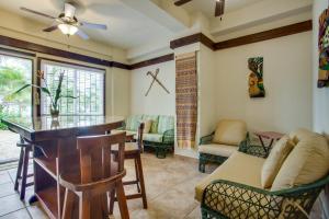a living room with a bar and chairs at Buttonwood Belize in Hopkins