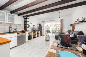 a kitchen and living room with a couch and a table at MEDANO4YOU The Bike Holiday Home in El Médano