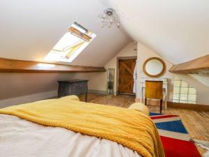 a bedroom with a large bed and a skylight at Charming 2-Bed Cottage in Otley in Otley