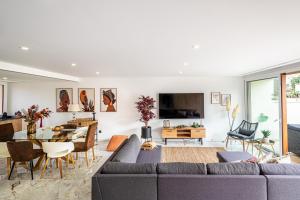 a living room with a couch and a table at BeGuest Albufeira Luxus Villa in Albufeira