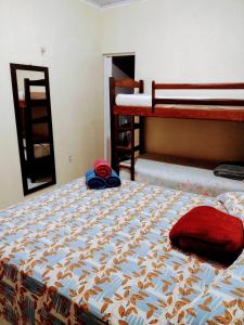 a bedroom with a bed and a bunk bed at Temporada no Atalaia in Salinópolis