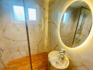 a bathroom with a sink and a mirror at Manchester Regency - 2BR Apartment in Dubai Marina in Dubai