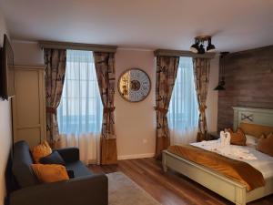 1 dormitorio con 1 cama, 1 silla y ventanas en Casa Kempel, en Sibiu