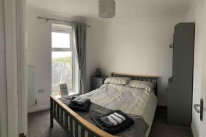 a bedroom with a bed with two pillows on it at Beachfront pet friendly townhouse, Stunning views in Port Talbot