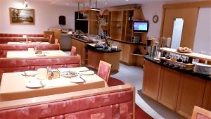 a restaurant with tables and chairs and a counter at Lärchenhof Serfaus in Serfaus
