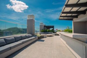 a balcony with couches and a view of the city at Resort de Reserva del Mar in Santa Marta