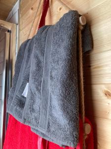 a gray sweater hanging on a wooden wall at Captivating 1-Bed Cabin in Middlesbrough in Middlesbrough