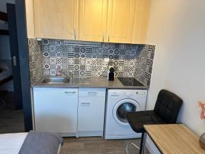 a kitchen with a washing machine and a sink at CALME-APPARTEMENT in La Grande Motte
