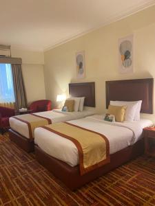 una habitación de hotel con 2 camas en una habitación en Al Diar Mina Hotel en Abu Dabi