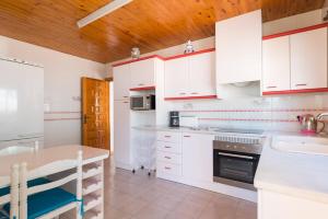 a kitchen with white cabinets and a counter top at Villa Andres - PlusHolidays in Calpe