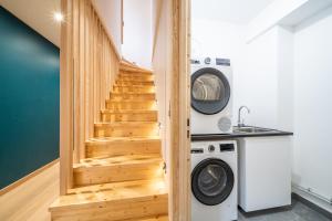 a room with a staircase and a washer and dryer at Chalet Arande Saint Gervais - by EMERALD STAY in Saint-Gervais-les-Bains