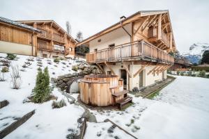 a building with a hot tub in the snow at Chalet Arande Saint Gervais - by EMERALD STAY in Saint-Gervais-les-Bains