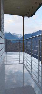 a balcony with a view of the mountains at Shrikanth Homestay in Joshīmath
