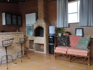 a living room with a couch and a brick oven at Loft em Cobertura in Rio de Janeiro