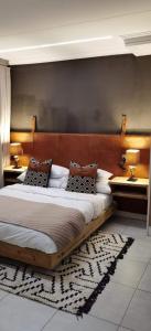 a bedroom with a large bed with two tables at The Blyde Apartment 1287 in Pretoria