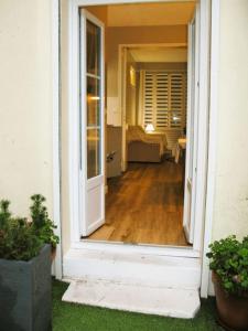 an open door of a house with a hallway at Studio/Patio pour 3 hypercentre! in Le Touquet-Paris-Plage