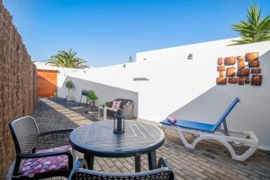 a patio with a ping pong table and chairs at Casa Timanfaya in Playa Blanca