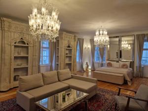 a living room with a couch and a chandelier at AB Ljubljana - Breg Apartments in Ljubljana