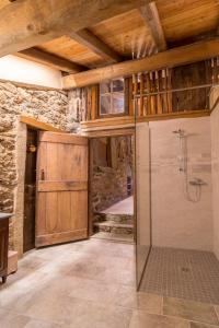 a bathroom with a shower and a wooden ceiling at La Mason dla Grà in Frassinetto