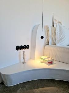 a bedside table with a book and a lamp at Ivy's Natural Resort in Arnados