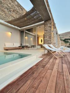 a house with a swimming pool and a wooden floor at Ivy's Natural Resort in Arnados