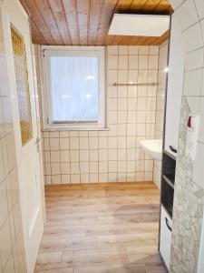 a bathroom with a sink and a window at NaturCampingplatz Bad Mergentheim - Ferienwohnungen in der Natur in Bad Mergentheim