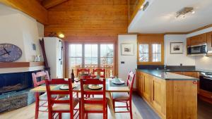 a kitchen and dining room with a table and chairs at Terrasses du Paradis 7A LUXE & CENTER apart 8 pers in Nendaz