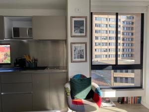 a kitchen with a counter and a chair in a room at Apartamento Park Way Bogotá in Bogotá