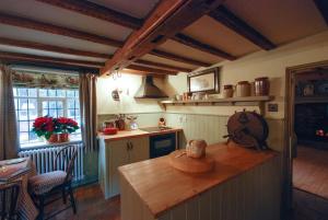 a kitchen with a wooden counter top in a room at Laundry Cottage in a Nature Reserve - Sunday Times 100 coolest Cottages in Farnham